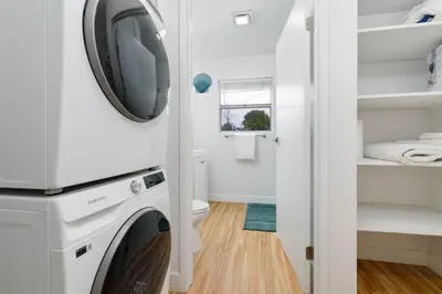 a laundry room with a washer and dryer at Mar Vista 2BR Retreat Office Huge Backyard in Los Angeles