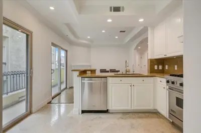 a kitchen with white cabinets and a large window at Los Angeles Beverly Hills Westside UCLA Luxury in Los Angeles