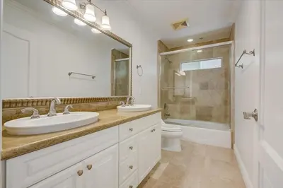 a white bathroom with two sinks and a shower at Los Angeles Beverly Hills Westside UCLA Luxury in Los Angeles