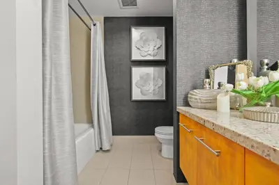 a bathroom with a tub and a toilet and a sink at Luxe DTLA Escape - Walk to Games, Events, & Dining in Los Angeles