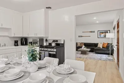 a kitchen and living room with a table and chairs at Relax in Stylish 3BR with Fire Pit Gym and Parking in Los Angeles