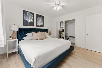 a bedroom with a large bed with a ceiling fan at Relax in Stylish 3BR with Fire Pit Gym and Parking in Los Angeles