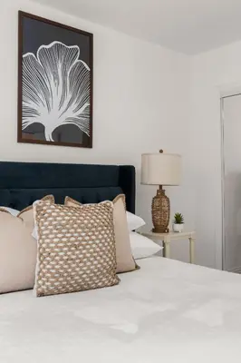 a bedroom with a bed with a pillow and a picture on the wall at Relax in Stylish 3BR with Fire Pit Gym and Parking in Los Angeles
