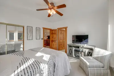 a bedroom with a bed and a ceiling fan at Deer Creek Lodge Mtn Getaway in Lake Arrowhead! in Lake Arrowhead