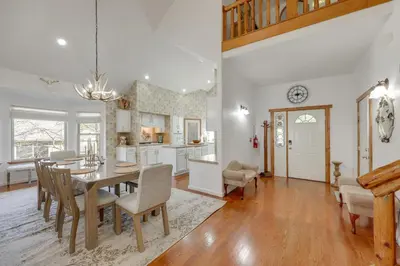 a dining room and kitchen with a table and chairs at Deer Creek Lodge Mtn Getaway in Lake Arrowhead! in Lake Arrowhead