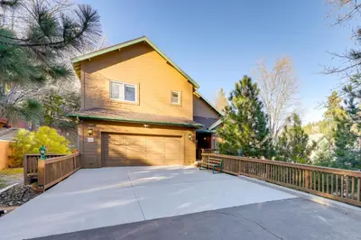 a house with a wooden fence and a garage at Deer Creek Lodge Mtn Getaway in Lake Arrowhead! in Lake Arrowhead