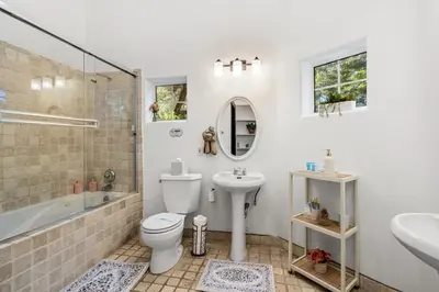 a bathroom with a toilet and a sink and a shower at Hillside Retreat Near Universal Studios & Hollywood Sign in Los Angeles
