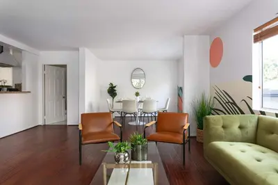 a living room with a table and chairs at Luxury 4BR Townhouse Sleeps 10 with Parking in McNeil