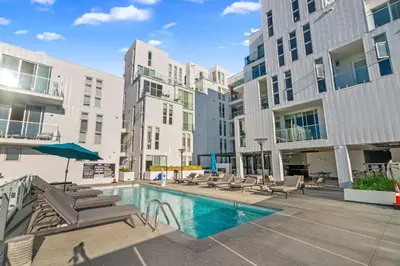 a swimming pool with lounge chairs and a building at Luxury Marina Penthouse Private Suite with Pool in Los Angeles