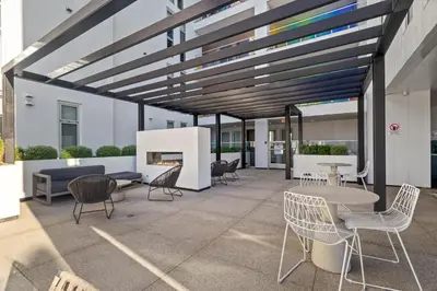 a patio with chairs and tables and a fireplace at Luxury Marina Penthouse Private Suite with Pool in Los Angeles