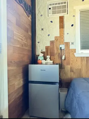 a small refrigerator in a room with a wall at Zaromelranch