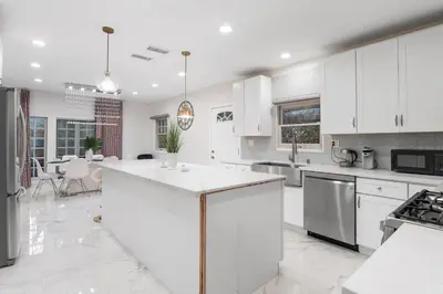 a kitchen with white cabinets and a white counter top at Luxe 6BR Retreat with Trampoline Swing and BBQ Grill in Los Angeles