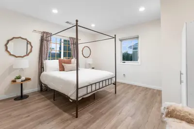 a bedroom with a four poster bed and a mirror at Luxe 6BR Retreat with Trampoline Swing and BBQ Grill in Los Angeles