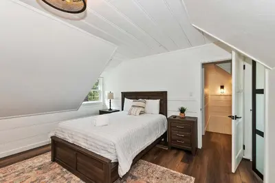 a white bedroom with a bed and a window at Highland Cedar Cabin WHot Tub Close to Village in Big Bear Lake