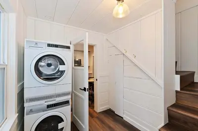 a washer and dryer in a room with a staircase at Highland Cedar Cabin WHot Tub Close to Village in Big Bear Lake