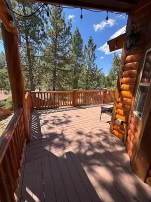 a large wooden deck on the side of a cabin at Lakewood Timber Lodge Peaceful Private in Big Bear Lake