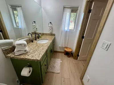 a bathroom with a sink and a mirror at Lakewood Timber Lodge Peaceful Private in Big Bear Lake