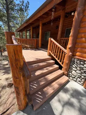 a wooden porch of a log cabin with stairs at Lakewood Timber Lodge Peaceful Private in Big Bear Lake