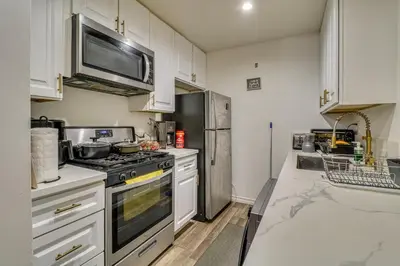 a kitchen with a stove and a microwave at Extended Stay in the Valley Gated and Convenient! in Tarzana