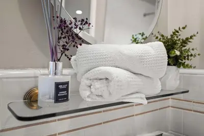 a pile of towels on a counter in a bathroom at Spacious 5BR LA Villa with Pool Spa & Game Room in Los Angeles