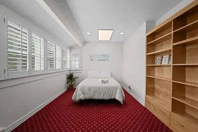 a bedroom with a bed and a red carpet at Spacious 5BR LA Villa with Pool Spa & Game Room in Los Angeles