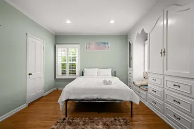 a bedroom with a large bed with white cabinets at Spacious 5BR LA Villa with Pool Spa & Game Room in Los Angeles