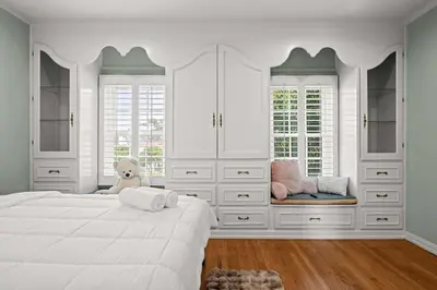 a white bedroom with a large bed and a teddy bear at Spacious 5BR LA Villa with Pool Spa & Game Room in Los Angeles