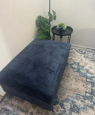 a black mattress sitting on a floor next to a table at Cozy private room in Santa Monica in Los Angeles