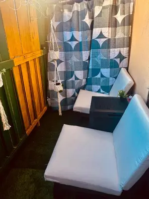 a room with two chairs and a table and a laptop at Cozy private room in Santa Monica in Los Angeles