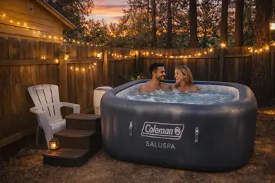 a man and a woman sitting in a hot tub at In the Pines Romantic Big Bear Forest Cabin in Fawnskin
