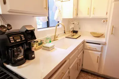a kitchen counter with a sink and a microwave at In the Pines Romantic Big Bear Forest Cabin in Fawnskin