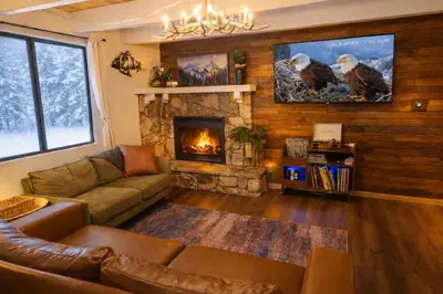 a living room with a couch and a fireplace at In the Pines Romantic Big Bear Forest Cabin in Fawnskin
