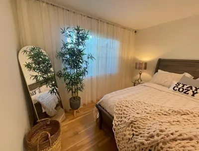 a bedroom with a bed and two potted plants at 4BR Home near Universal - Private Pool, BBQ, Free Parking in Hickson