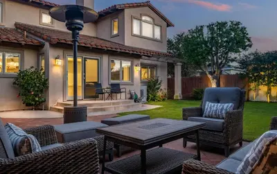 a patio with chairs and a table in front of a house at Luxury Retreat with Private Yard close to Beaches and FIFA Sleeps 10 in Torrance