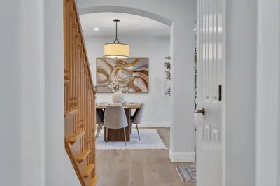 a hallway with a dining room table with a painting at Luxury Retreat with Private Yard close to Beaches and FIFA Sleeps 10 in Torrance