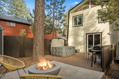 a backyard with a fire pit next to a house at Hearthmoon Haven in Big Bear Lake