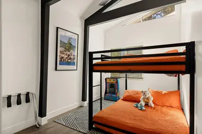a bedroom with two bunk beds with a teddy bear on the bed at Hearthmoon Haven in Big Bear Lake
