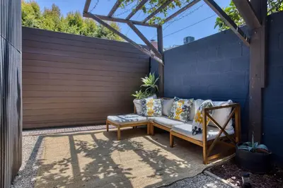 a patio with a couch and a chair at Brand-New MCM Guesthouse in West Los Angeles in Los Angeles