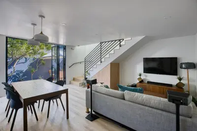 a living room with a couch and a table at Brand-New MCM Guesthouse in West Los Angeles in Los Angeles