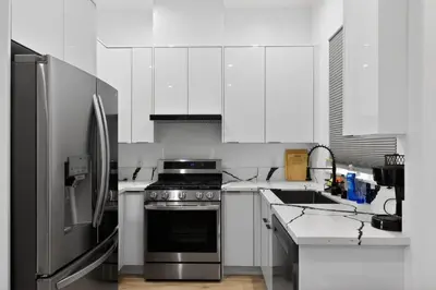 a kitchen with white cabinets and a stainless steel refrigerator at #01 Spacious 3B3B Near Koreatown & Hollywood, Central LA in Los Angeles