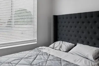 a bedroom with a bed with a headboard and a window at #01 Spacious 3B3B Near Koreatown & Hollywood, Central LA in Los Angeles