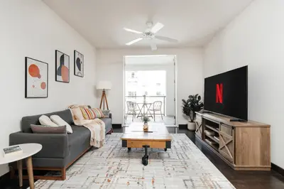 a living room with a couch and a flat screen tv at Cute 1Bedroom apartment with pool view, parking and GYM in Los Angeles
