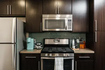 a kitchen with a stove and a microwave at Cute 1Bedroom apartment with pool view, parking and GYM in Los Angeles