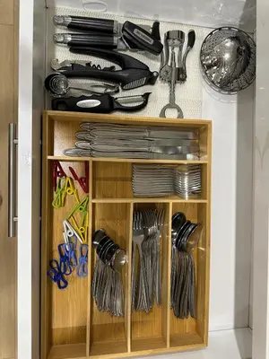 a wooden cabinet filled with utensils at Canyon House, Pool, Yard, BBQ, 14mi to Six Flags in Santa Clarita