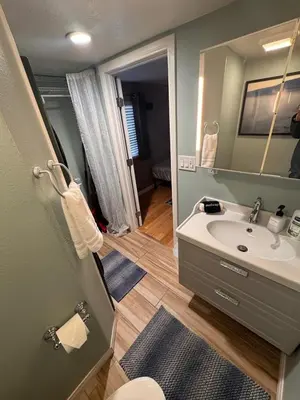 a bathroom with a sink and a mirror at Lakeview Location Hot tub Tesla Charger tree house in Big Bear Lake