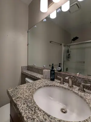 a bathroom with a sink and a large mirror at ENSUITE MASTER BEDROOM IN WEST HOLLYWOOD - super host in Los Angeles