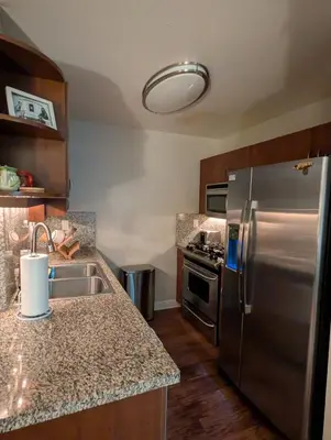 a kitchen with a sink and a stainless steel refrigerator at ENSUITE MASTER BEDROOM IN WEST HOLLYWOOD - super host in Los Angeles
