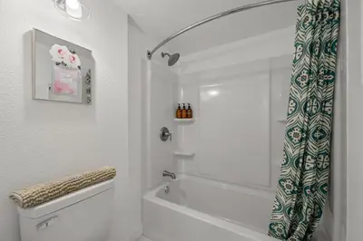 a white bathroom with a tub and a shower at LuxuryCondo DTAlhambra Near Starbucks Free2Parking in Alhambra