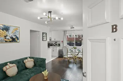 a living room with a green couch and a table at LuxuryCondo DTAlhambra Near Starbucks Free2Parking in Alhambra