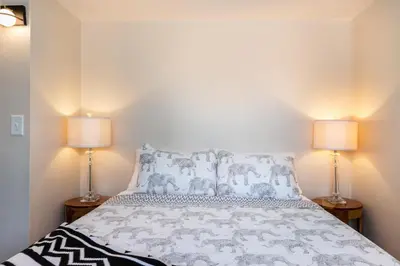 a bedroom with a bed with two lamps at SoCal Retreat with Pool and Spacious Backyard in Canoga Park
